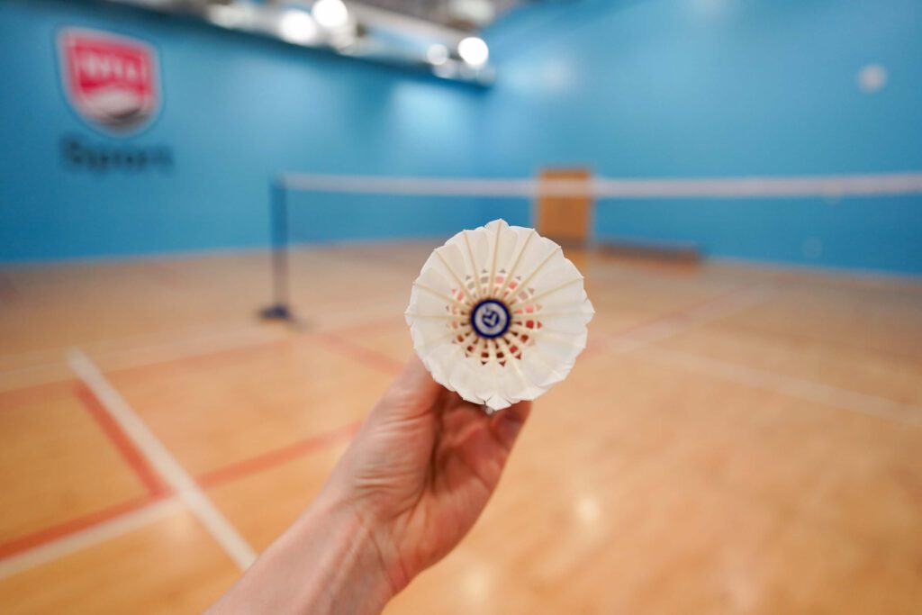 tipping badminton shuttlecock outwards to make it slower